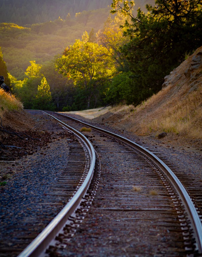 about-us-02 Serene view of a historic railway track in Ashland, Oregon during sunset.