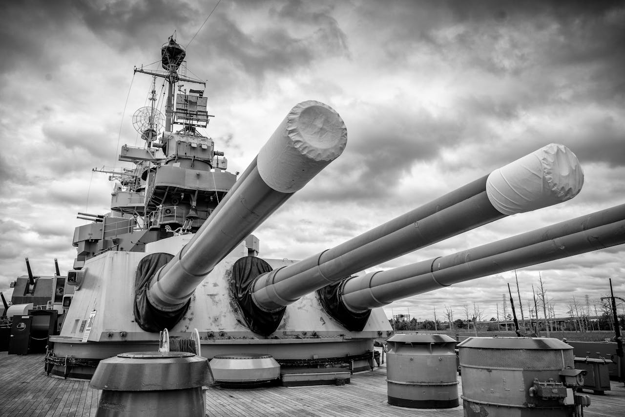 home-hero-2 Dramatic low angle shot of a battleship in Wilmington, NC in black and white.