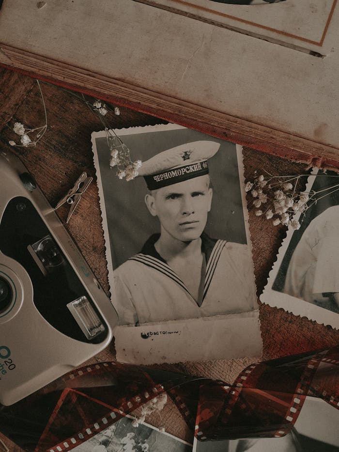 services-02 Soviet naval portrait with retro camera and flowers, evoking nostalgia.